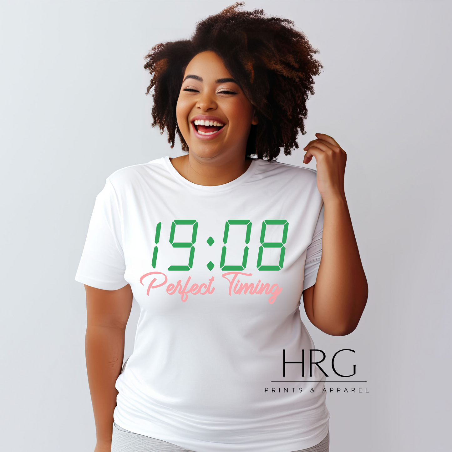 "Perfect Timing 1908 AKA-inspired t-shirt featuring green digital clock design and green text worn by a smiling African American woman."