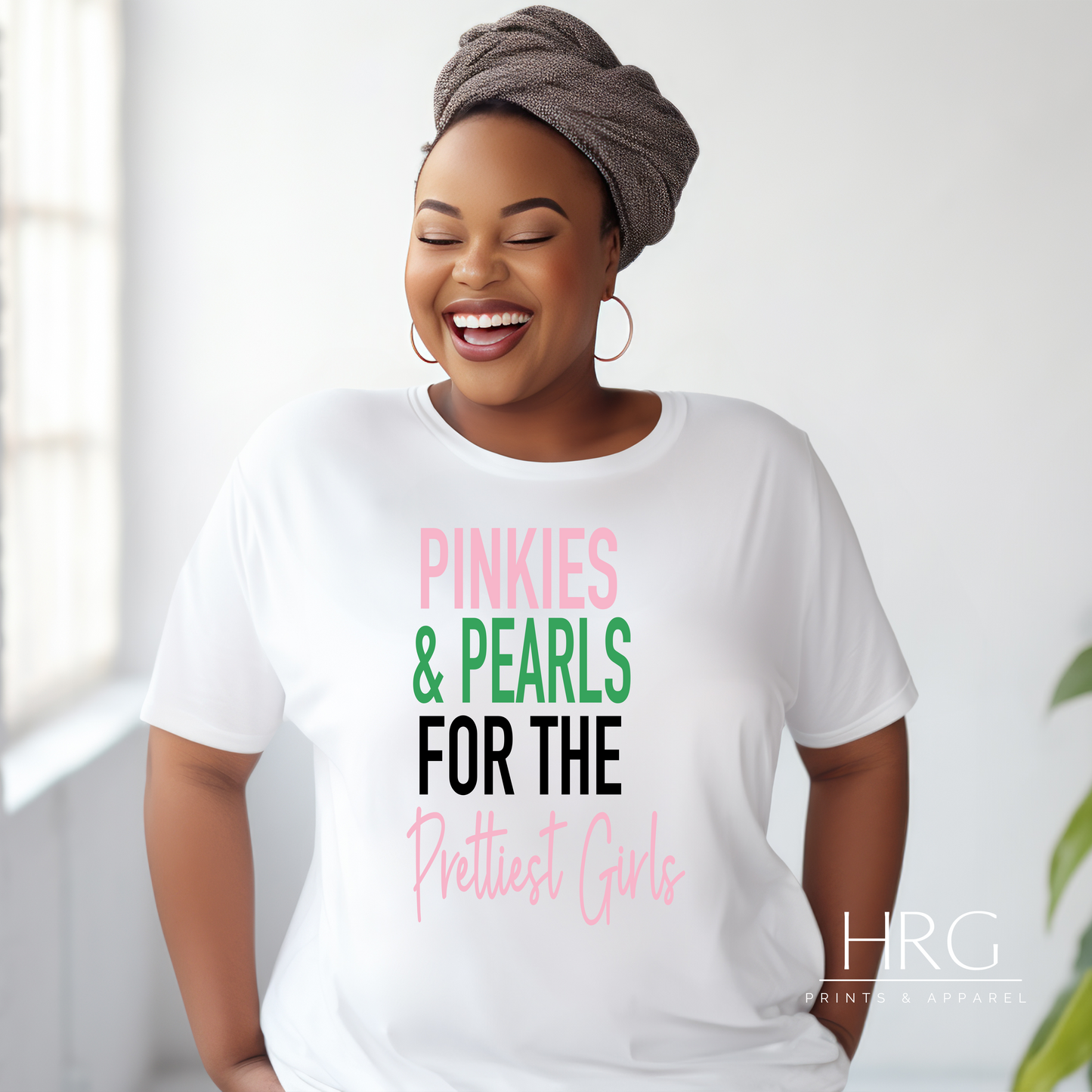 "Pinkies & Pearls For The Prettiest Girls - AKA-inspired t-shirt featuring pink and green design worn by a smiling African American woman"