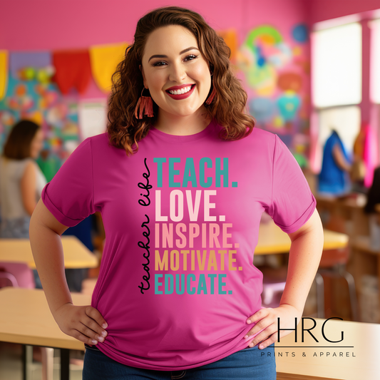 Teacher-themed t-shirt with the words 'Teacher Life. Teach. Love. Inspire. Motivate. Educate.' printed in stylish script, celebrating the passion and commitment of educators.